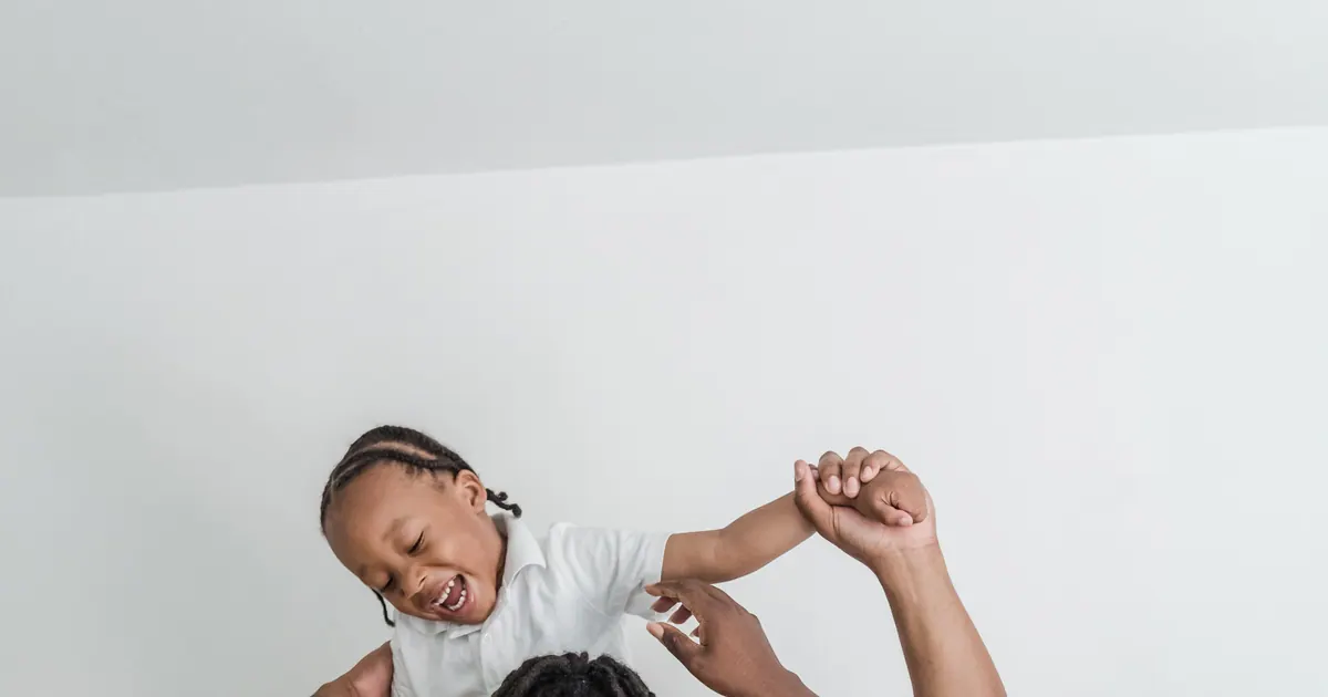 Parents sharing a playful moment with a child at home